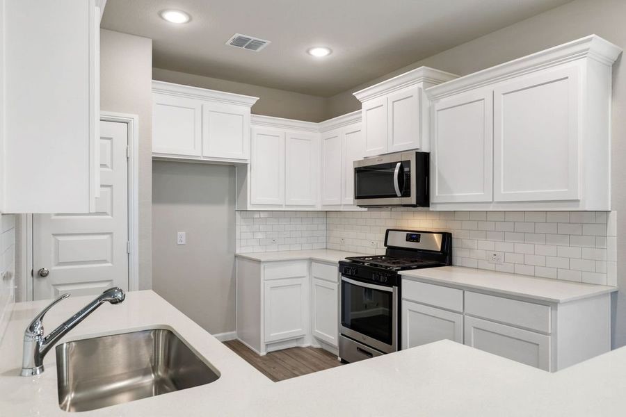Kitchen in the Sapphire home plan by Trophy Signature Homes – REPRESENTATIVE PHOTO Kitchen in the Sapphire home plan by Trophy Signature Homes – REPRESENTATIVE PHOTO