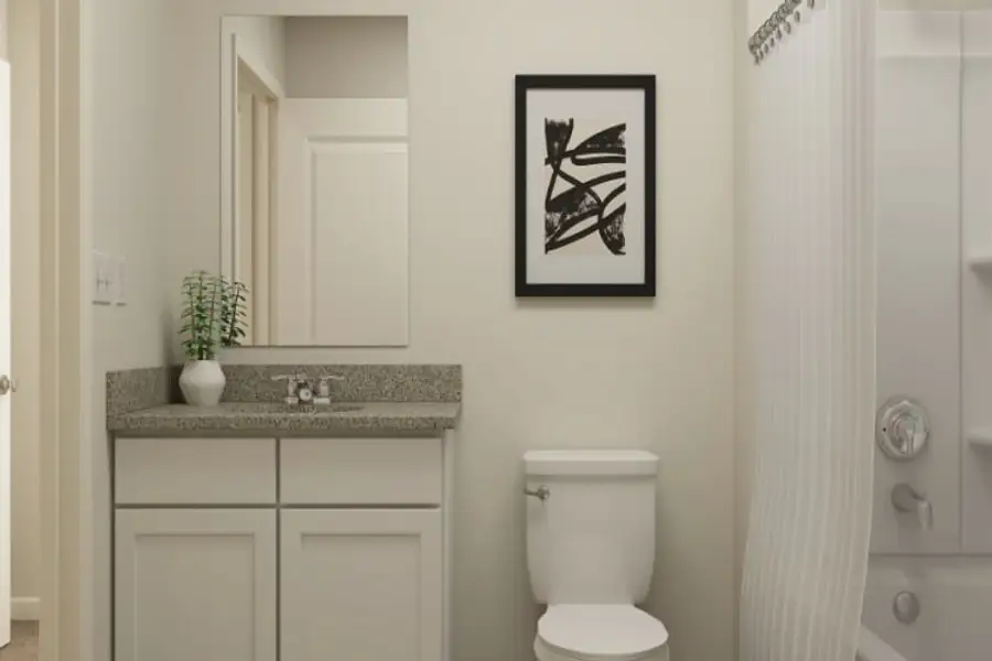 A bathroom with a sink toilet and a picture on the wall.
