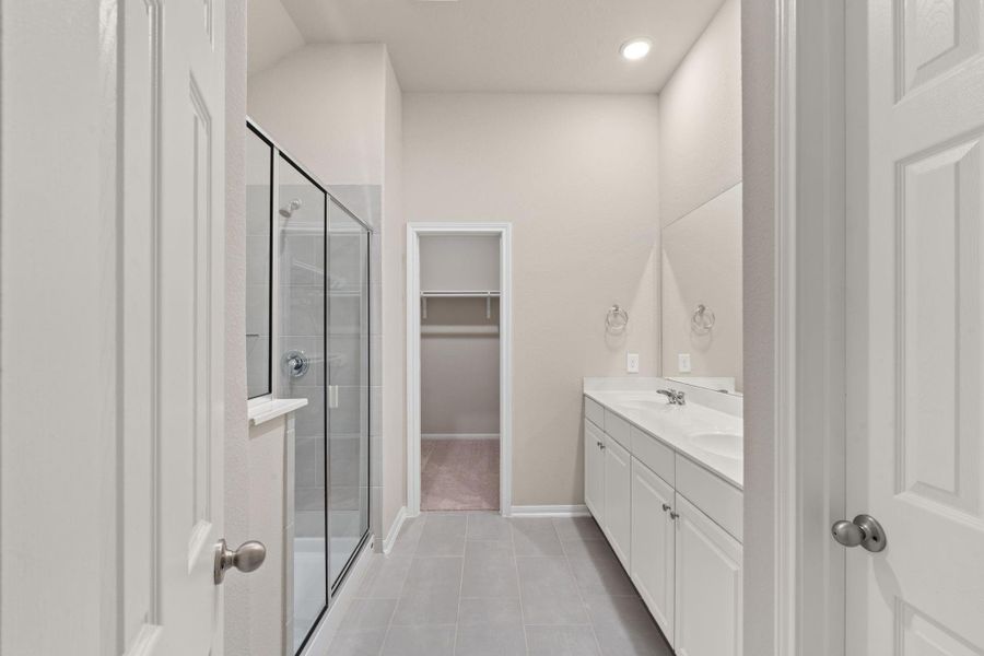 The primary bath features a Double vanity and glass enclosed shower.