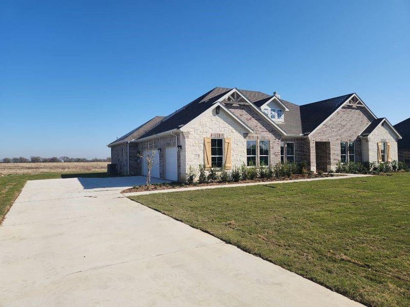 Front exterior of a new home in Rocky Top, Krum, TX, highlighting curb appeal (Image 1).