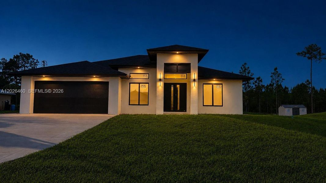 Front exterior of a new home in , Lehigh Acres, FL, highlighting curb appeal (Image 26).