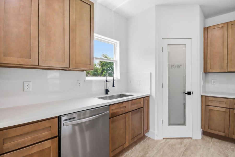 Convenient pantry with frosted glass door.