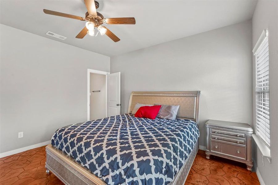 Primary Bedroom with ceiling fan and multiple windows