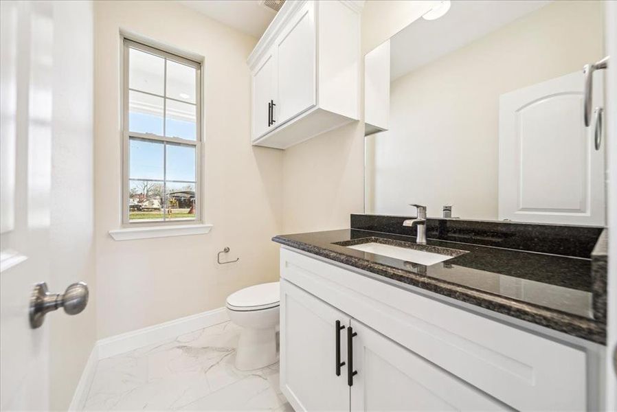 Bathroom featuring vanity and toilet