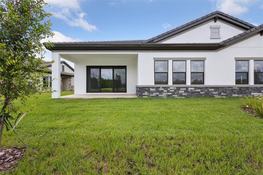 Front exterior of a new home in Two Rivers, Zephyrhills, FL, highlighting curb appeal (Image 2).