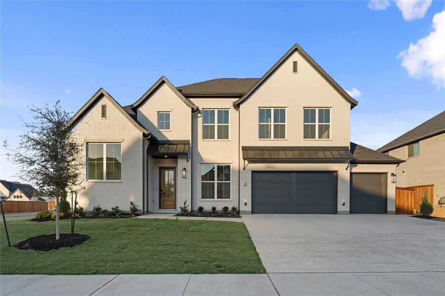 Front exterior of a new home in Light Farms Graham/Reagan, Celina, TX, highlighting curb appeal (Image 26). Front exterior of a new home in Light Farms Graham/Reagan, Celina, TX, highlighting curb appeal (Image 26).