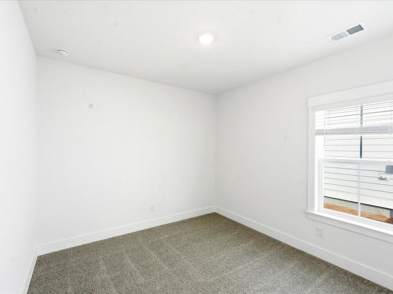 Spacious, unfurnished interior of a new home in The Coves at Lakes of Cane Bay II, Summerville (Image 33).