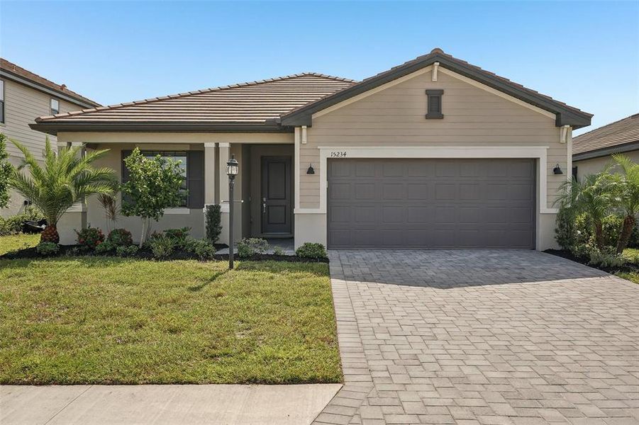 Front exterior of a new home in , Lakewood Ranch, FL, highlighting curb appeal (Image 2). Front exterior of a new home in , Lakewood Ranch, FL, highlighting curb appeal (Image 2).