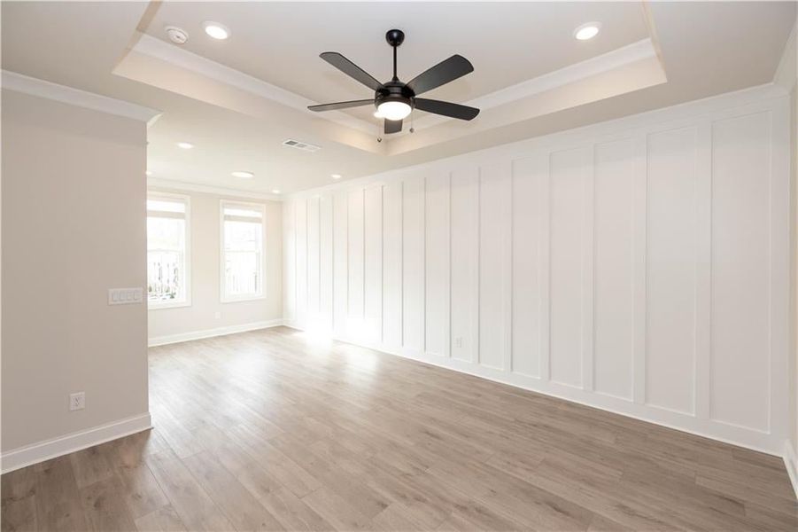 Owners Suite with decorative trim accent wall, trey ceiling and and custom designed closet.