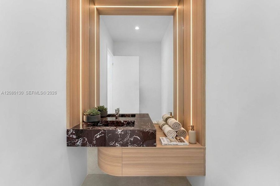 Powder Room. Disclaimer: Several photographs presented in this listing contain digitally added furniture, artwork, and decor. These virtually staged images are intended solely for illustrative purposes.