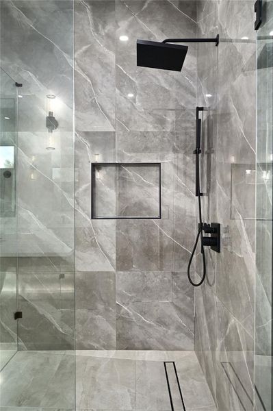 Bathroom with a marble finish shower