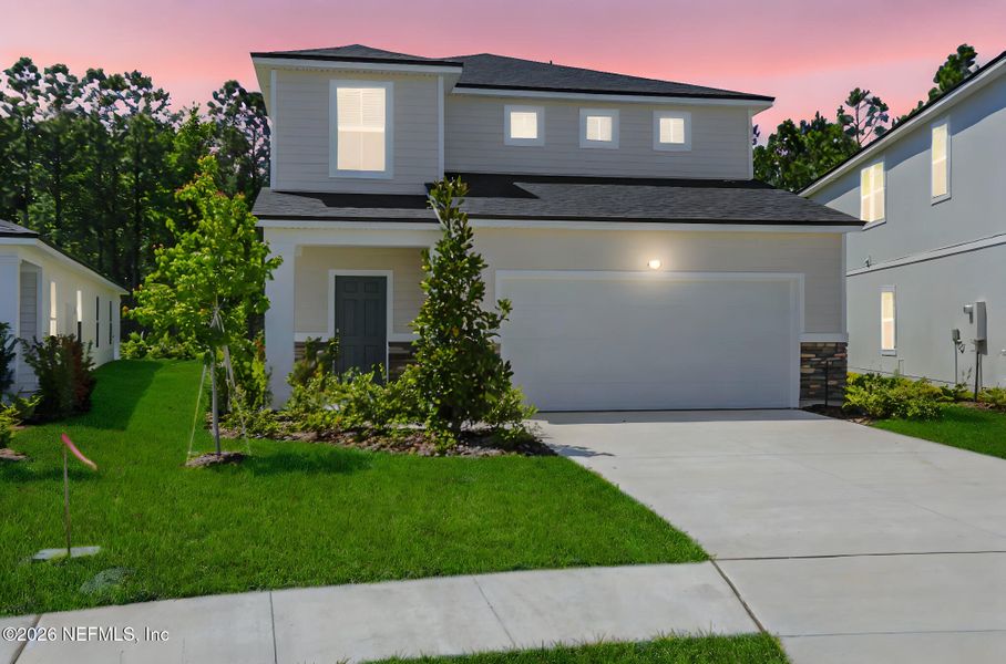 Front exterior of a new home in Amberly, Green Cove Springs, FL, highlighting curb appeal (Image 22).