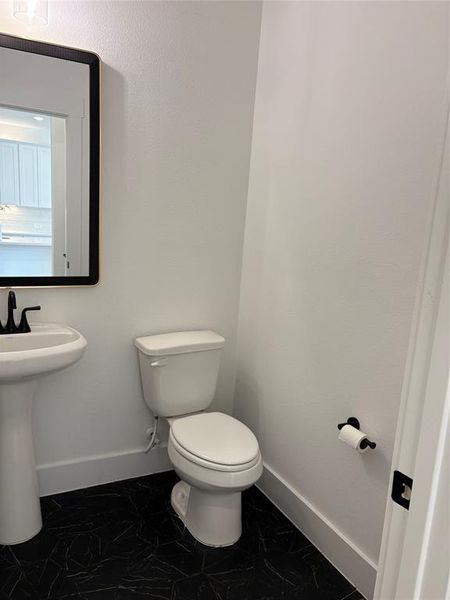 Bathroom with baseboards and toilet