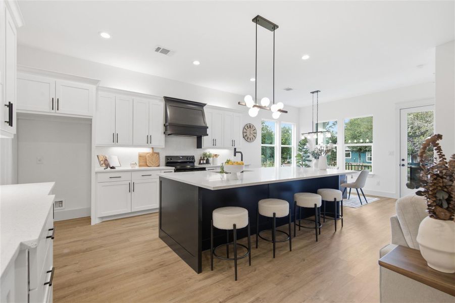 A well-appointed kitchen showcasing an inviting island with seating and sleek contemporary fixtures. A well-appointed kitchen showcasing an inviting island with seating and sleek contemporary fixtures.