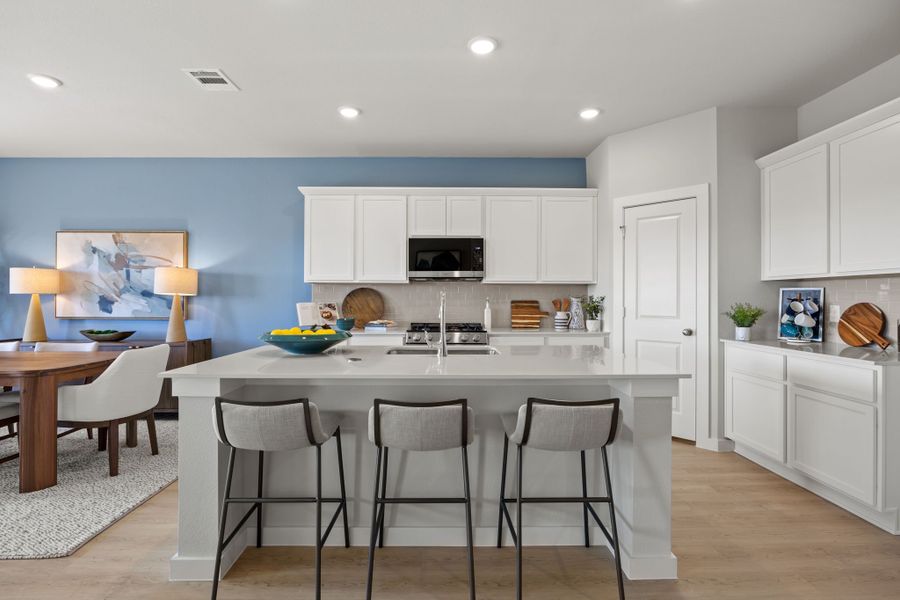 A kitchen with white cabinets. A kitchen with white cabinets.