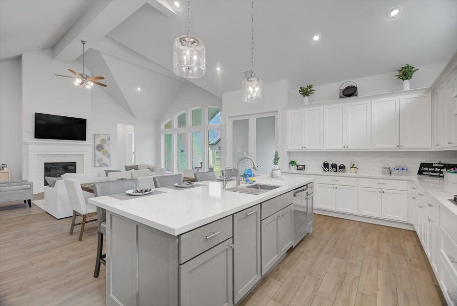 This beautiful open floor plan allows you to host and entertain effortlessly, with 15' ceilings, abundant recessed lighting, and a wall of windows that fills the entire space with natural light and connects seamlessly to the outdoor area.