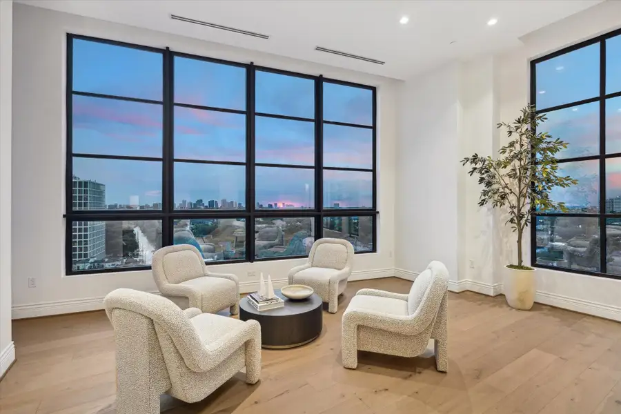 Wrapped in natural light, this intimate corner of the gathering room is framed by stunning floor-to-ceiling windows on two sides.. A perfect spot for morning coffee or evening conversation, this sophisticated sitting area invites you to relax while taking in the wraparound views. Wrapped in natural light, this intimate corner of the gathering room is framed by stunning floor-to-ceiling windows on two sides.. A perfect spot for morning coffee or evening conversation, this sophisticated sitting area invites you to relax while taking in the wraparound views.