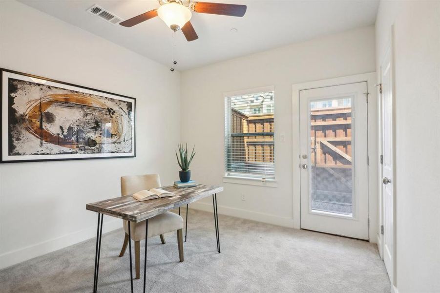 Office area featuring ceiling fan and light carpet