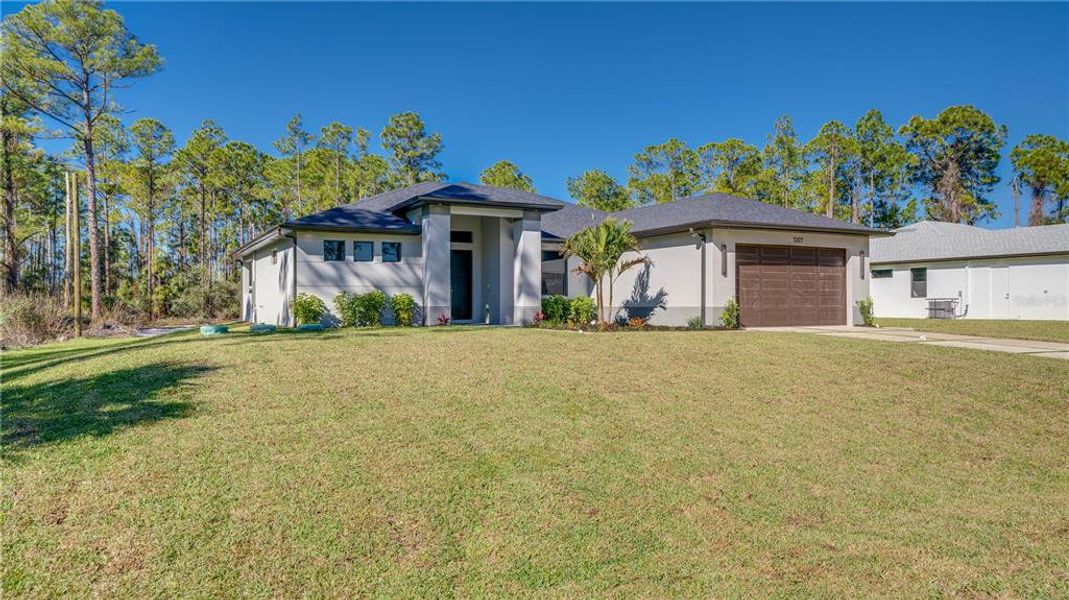 Front exterior of a new home in , Lehigh Acres, FL, highlighting curb appeal (Image 29). Front exterior of a new home in , Lehigh Acres, FL, highlighting curb appeal (Image 29).