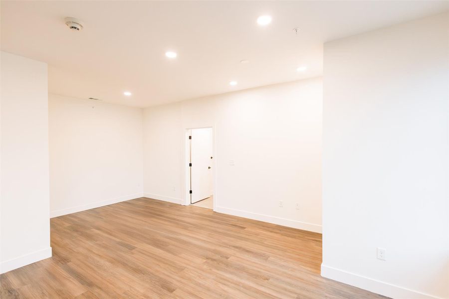 Empty room with recessed lighting and light wood-style flooring