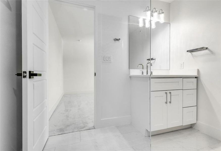 Bathroom with tile flooring and vanity