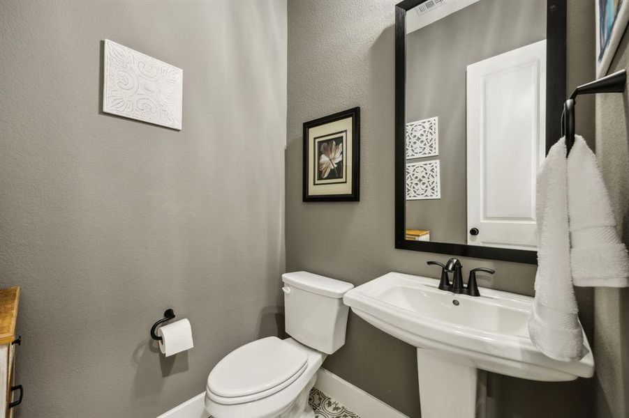 Half bath with toilet and baseboards