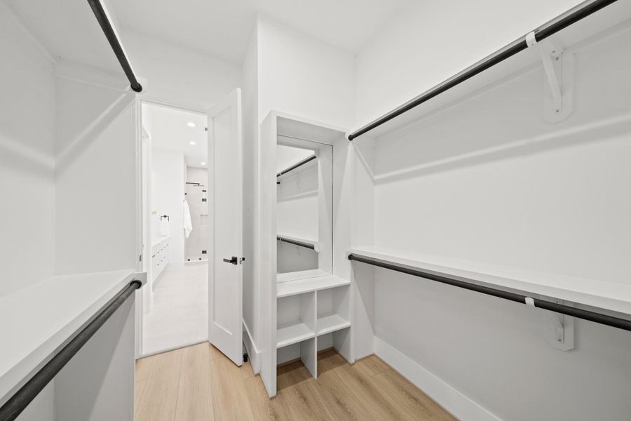 The walk-in closet has an abundance of storage shelves, including a dressing mirror with a nook for shoes, hats or jewelry. The walk-in closet has an abundance of storage shelves, including a dressing mirror with a nook for shoes, hats or jewelry.