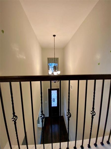 View from open gameroom to entry below with chandelier.