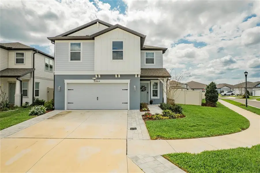 Front exterior of a new home in , Land O' Lakes, FL, highlighting curb appeal (Image 1). Front exterior of a new home in , Land O' Lakes, FL, highlighting curb appeal (Image 1).