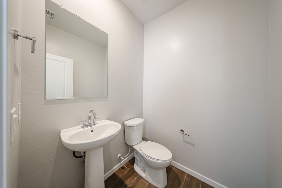 A bathroom with a toilet and sink.