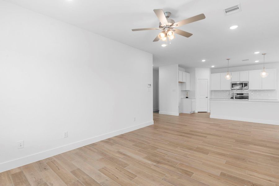 Tucked down the hallway with amazing carefree beautiful large plank wood looking tile floors will lead to the huge primary suite downstairs!  Simply stunning!