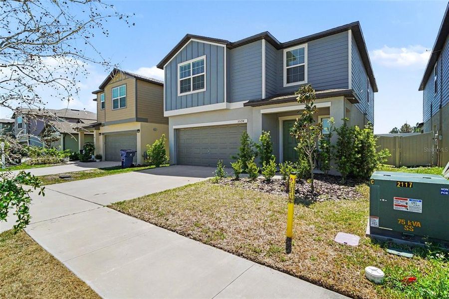 Front exterior of a new home in Two Rivers, Zephyrhills, FL, highlighting curb appeal (Image 21).