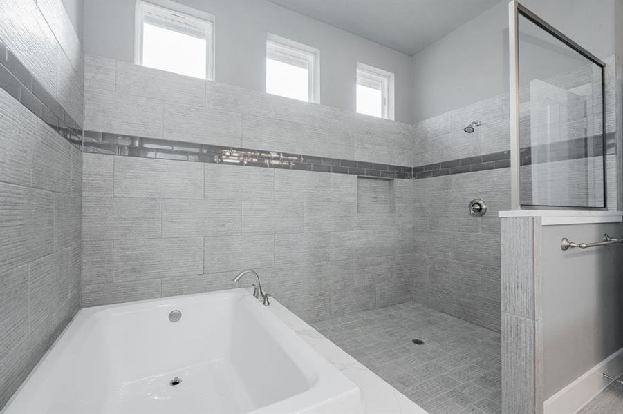 Bathroom featuring a garden tub and a walk in shower Bathroom featuring a garden tub and a walk in shower