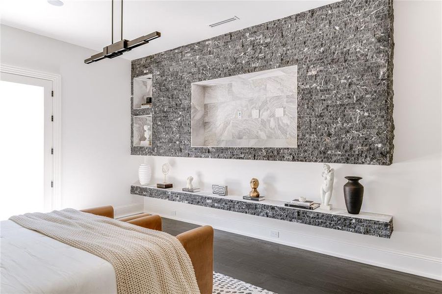 Bedroom with baseboards, visible vents, and wood finished floors