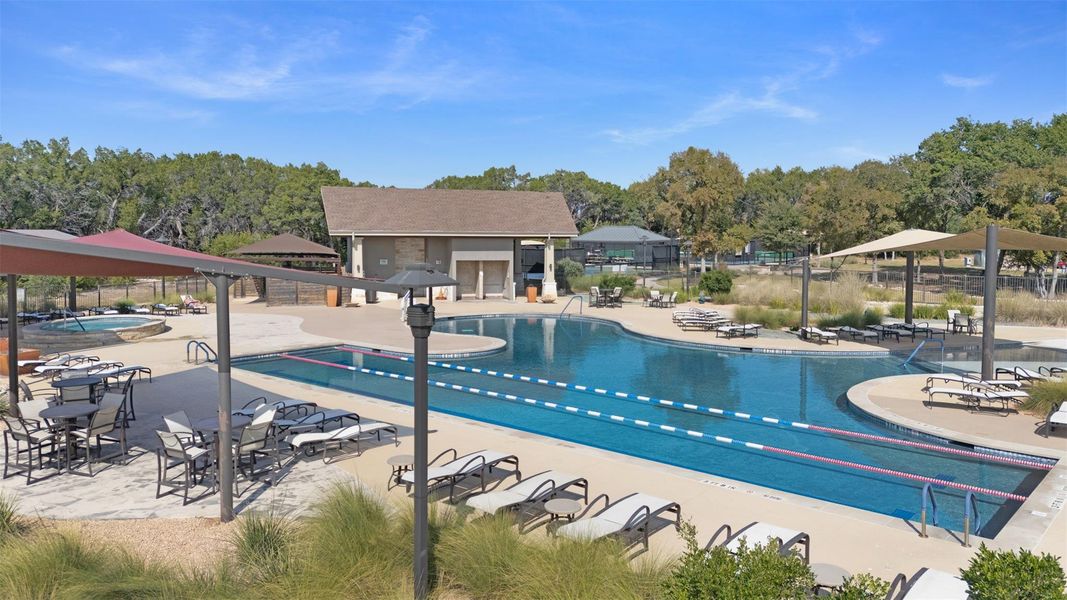 Expansive outdoor pool area featuring a multi-lane lap pool and a separate leisure pool Expansive outdoor pool area featuring a multi-lane lap pool and a separate leisure pool