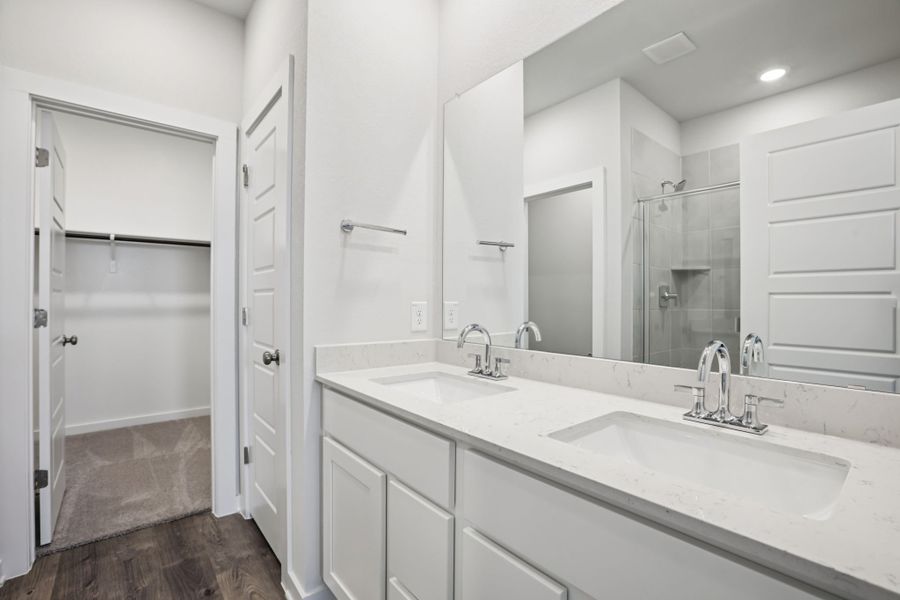 A bathroom with a large mirror.