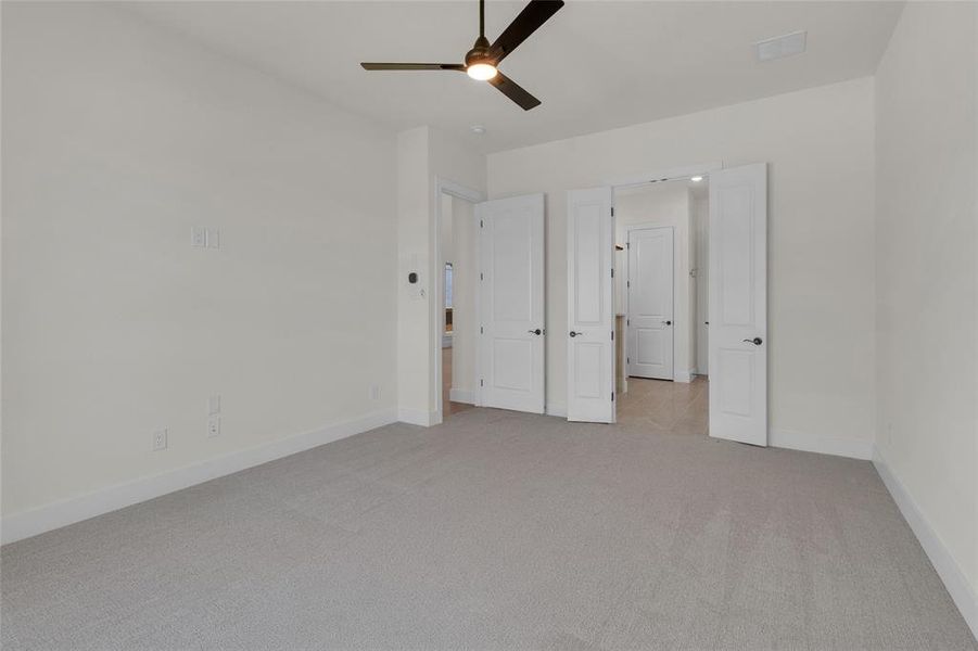 Neutral wall tones complement the light gray carpeting