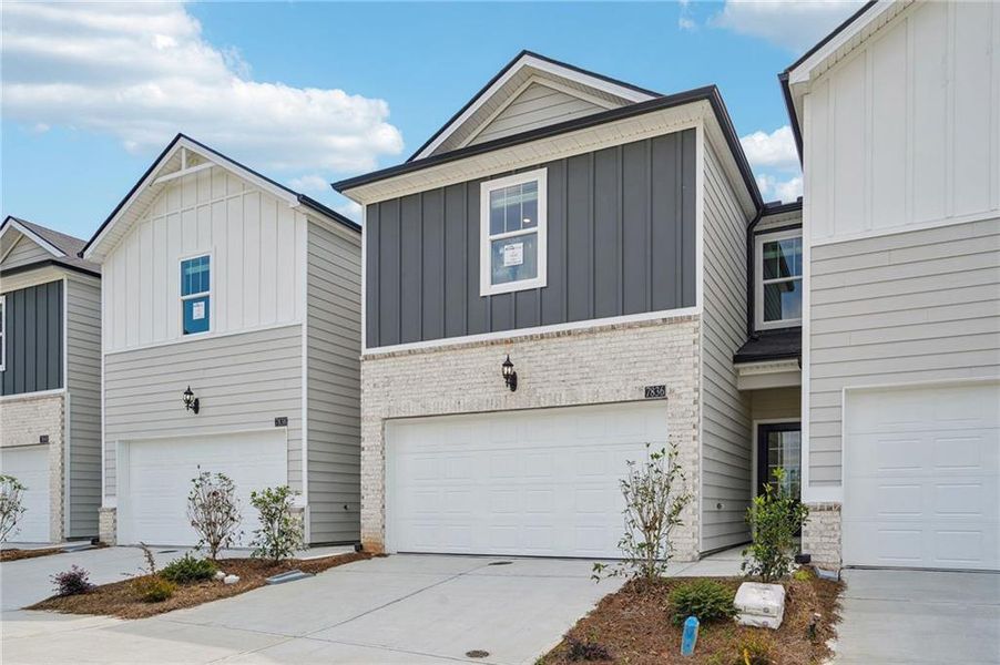 Front exterior of a new home in Artisan Walk, Fairburn, GA, highlighting curb appeal (Image 22).
