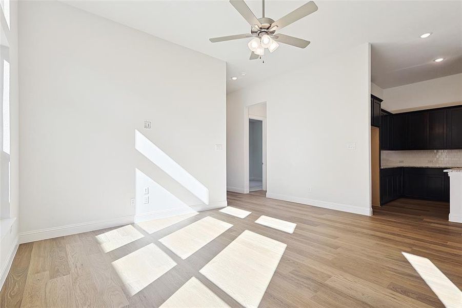 Unfurnished room featuring ceiling fan and light hardwood / wood-style flooring