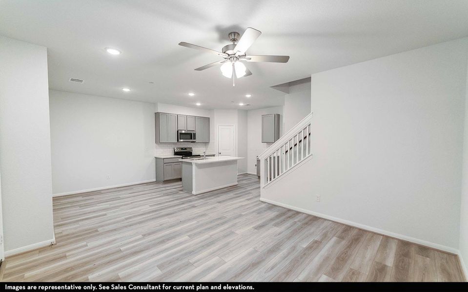 Kitchen featuring recessed lighting, a center island with sink, light countertops, gray cabinets, and ceiling fan