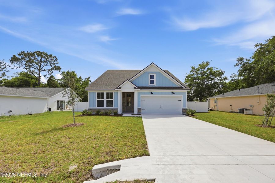 Front exterior of a new home in Palm Coast Homes, Palm Coast, FL, highlighting curb appeal (Image 27).