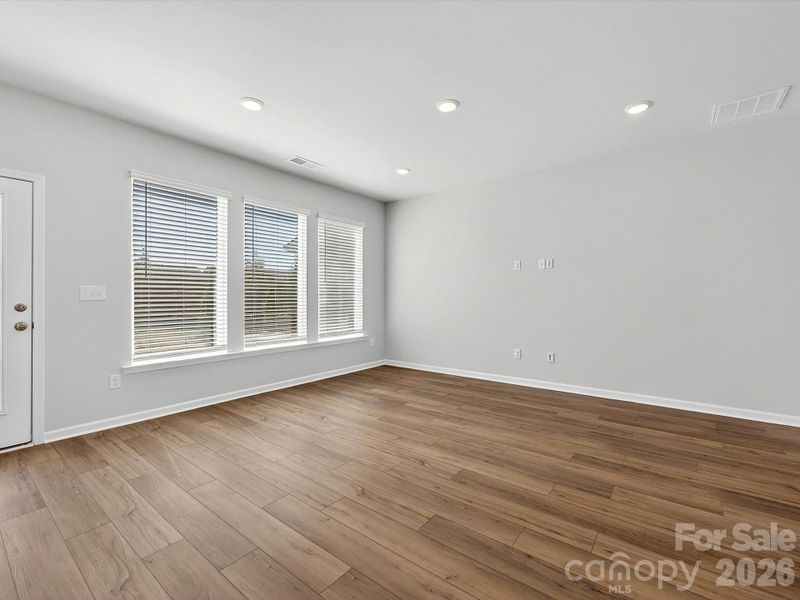 Open, bright living room with LVP flooring