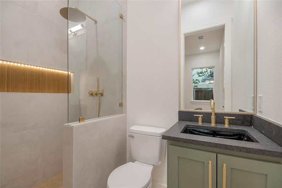 Bathroom featuring walk in shower and vanity