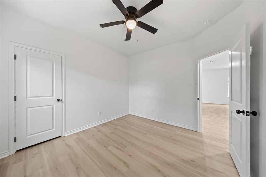 Unfurnished bedroom featuring light wood-style floors and ceiling fan