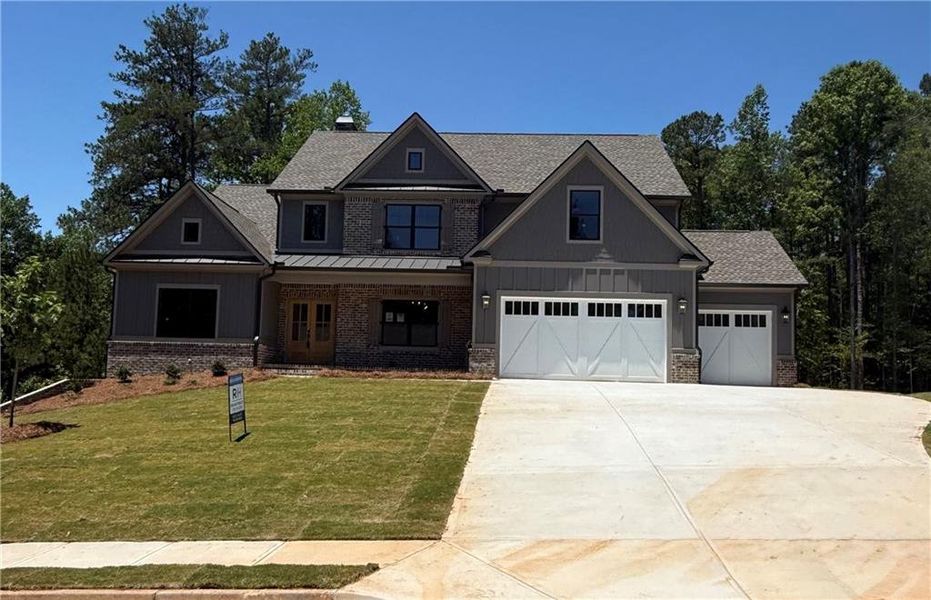 Front exterior of a new home in Spring Creek, Monroe, GA, highlighting curb appeal (Image 2). Front exterior of a new home in Spring Creek, Monroe, GA, highlighting curb appeal (Image 2).