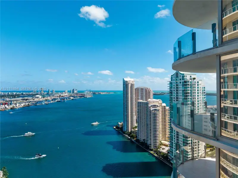 Curved private balconies with glass railings featuring floor-to-ceiling windows Curved private balconies with glass railings featuring floor-to-ceiling windows