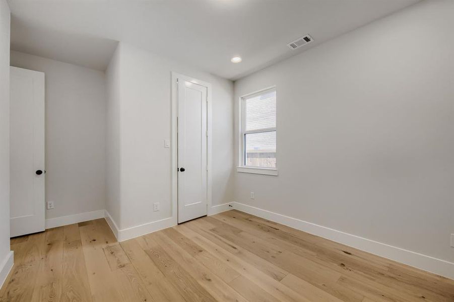 Light wood-finish flooring complements the neutral wall tones