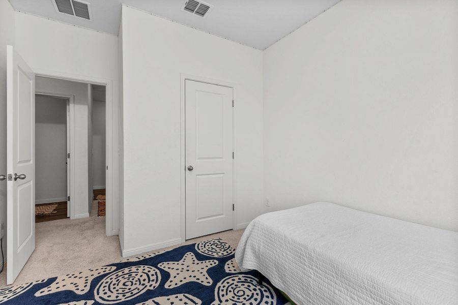 Bedroom with light carpet and baseboards Bedroom with light carpet and baseboards