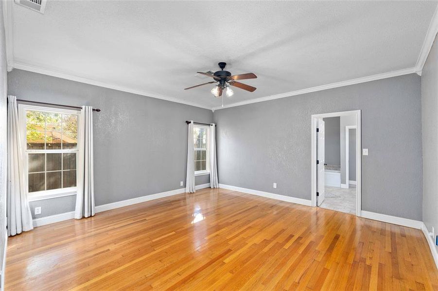 Primary bedroom with hardwood floors