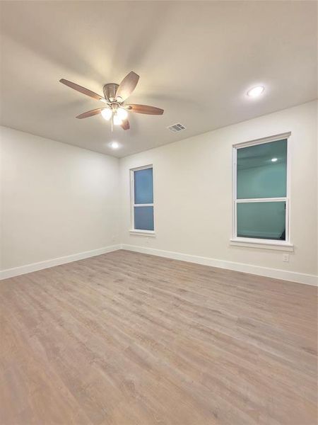Picture master/ primary bedroom and white high baseboards in room and throughout the house.